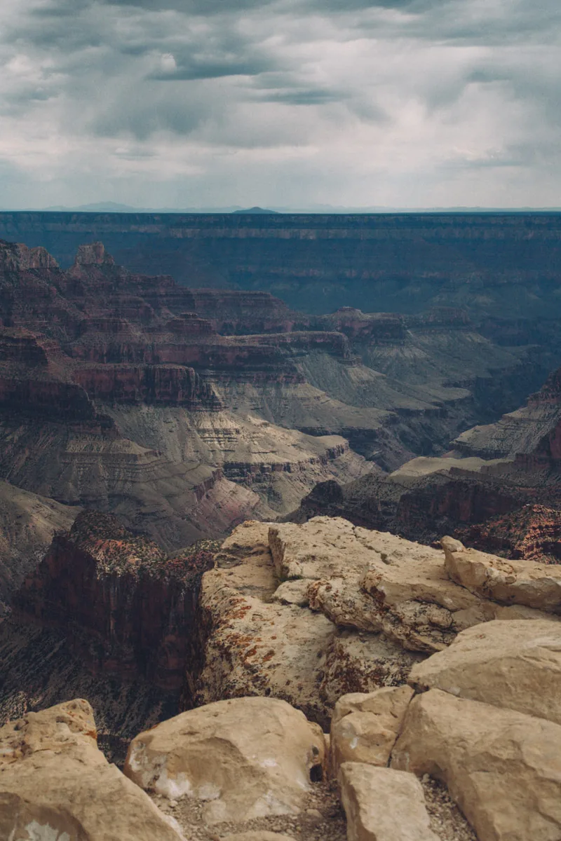 Rocks on the rim above the hazy canyon