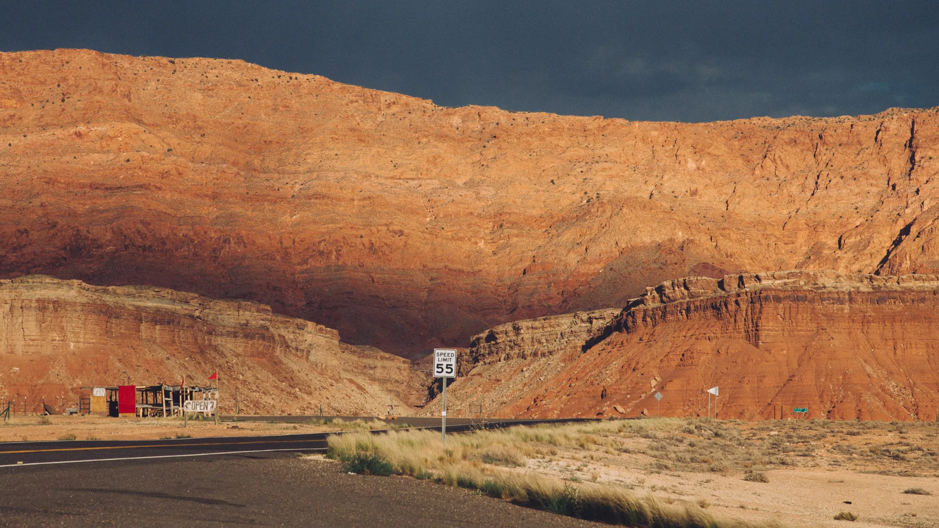 Sunlit cliffs above the road near Marble Canyon