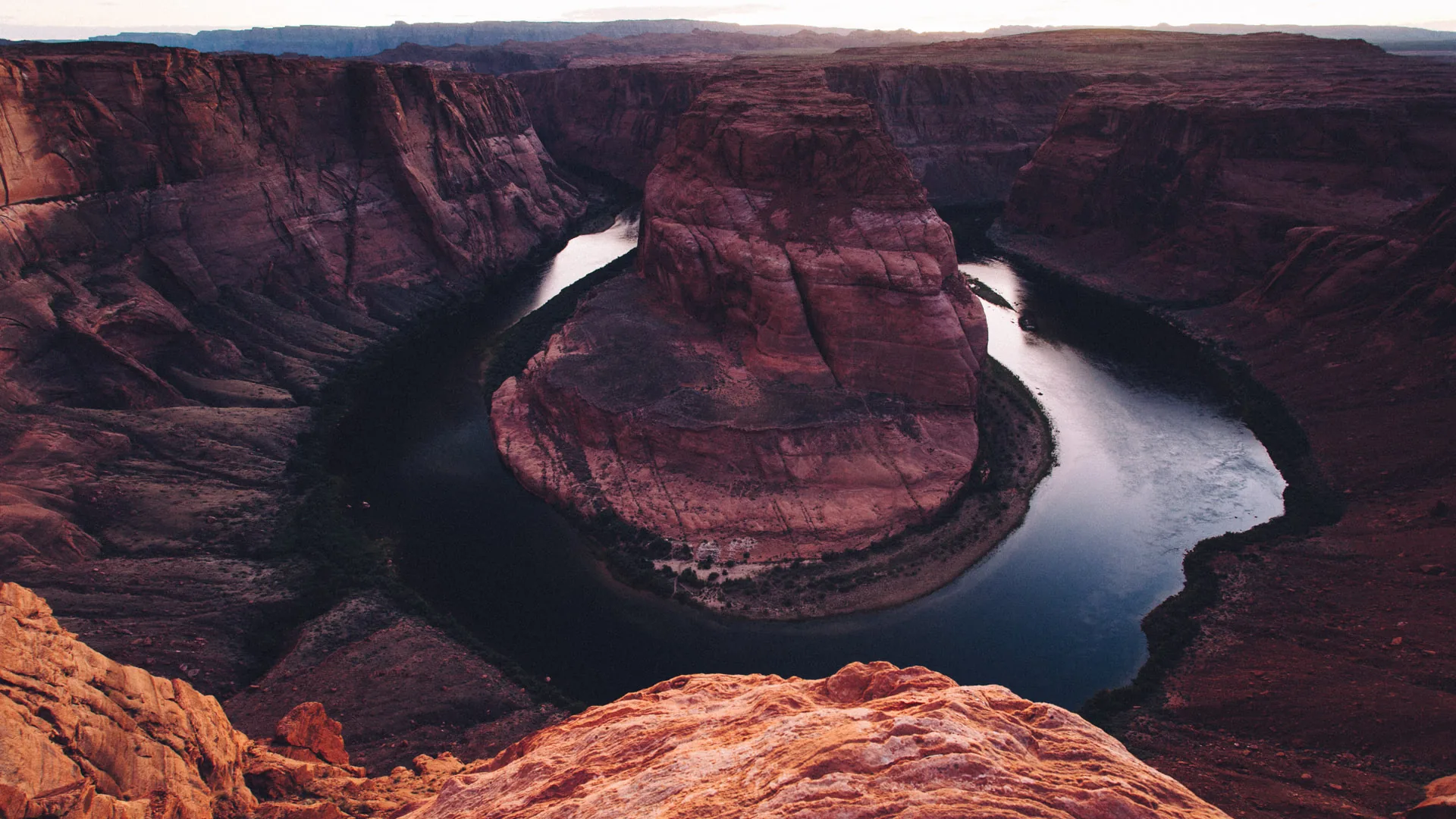 Horseshoe Bend seen from the edge, with the Colorado River far below