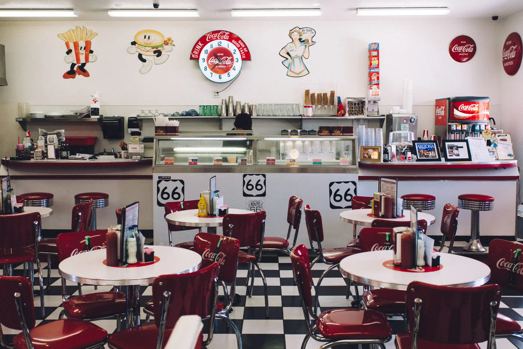 The red and white interior of Twisters, with checkered floor and Route 66 signs