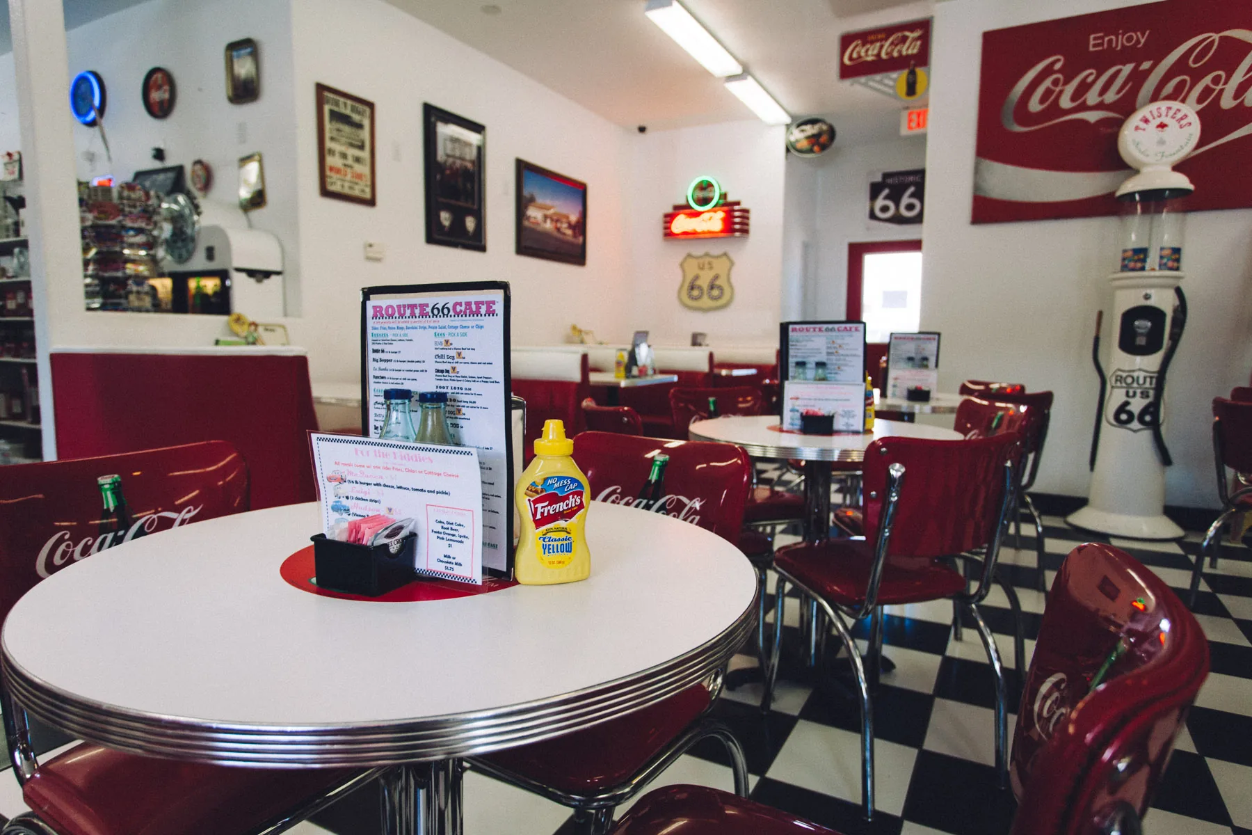 A diner table with mustard and menus inside Twisters