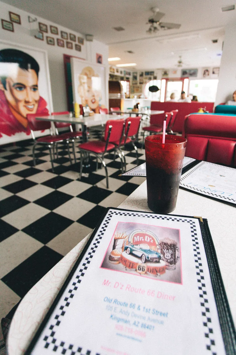 A drink and menu on a checkered table at Mr D'z