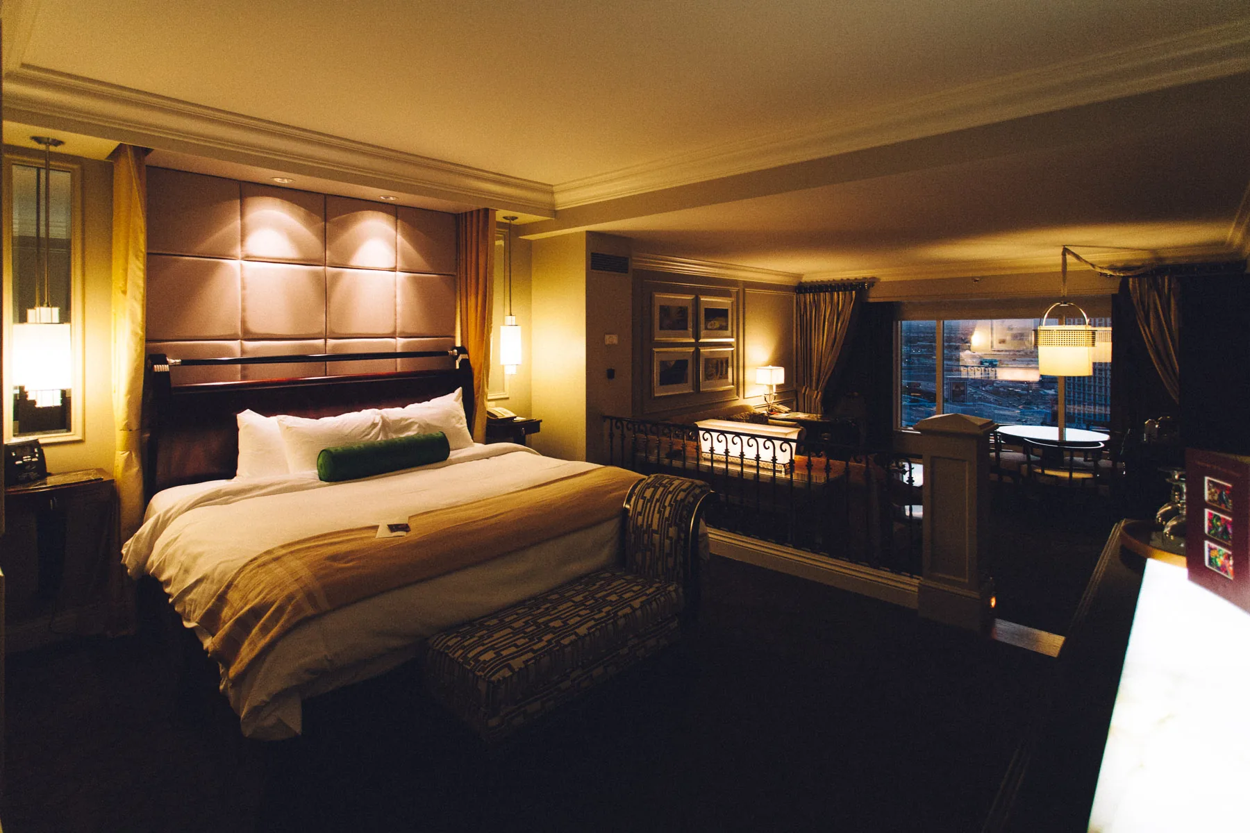 The Venetian suite bedroom lit by warm lamps