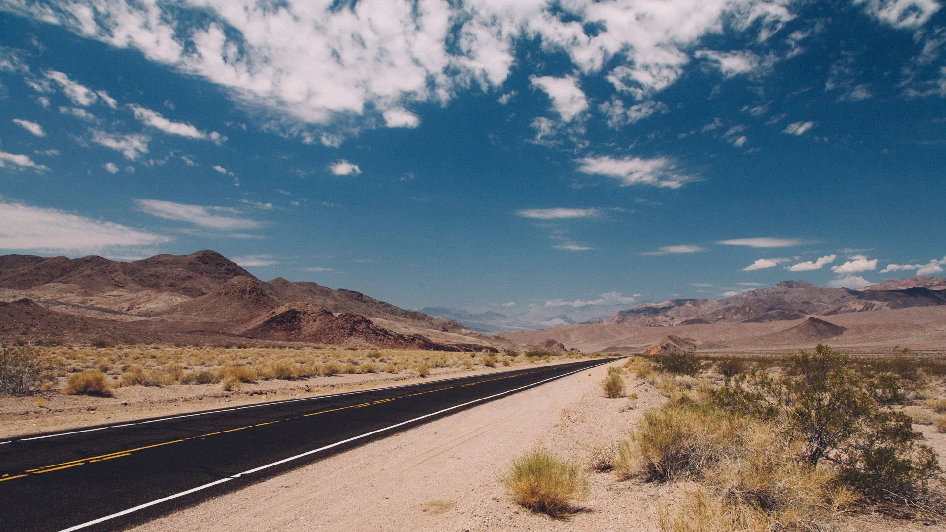 The road crossing the desert under a big sky