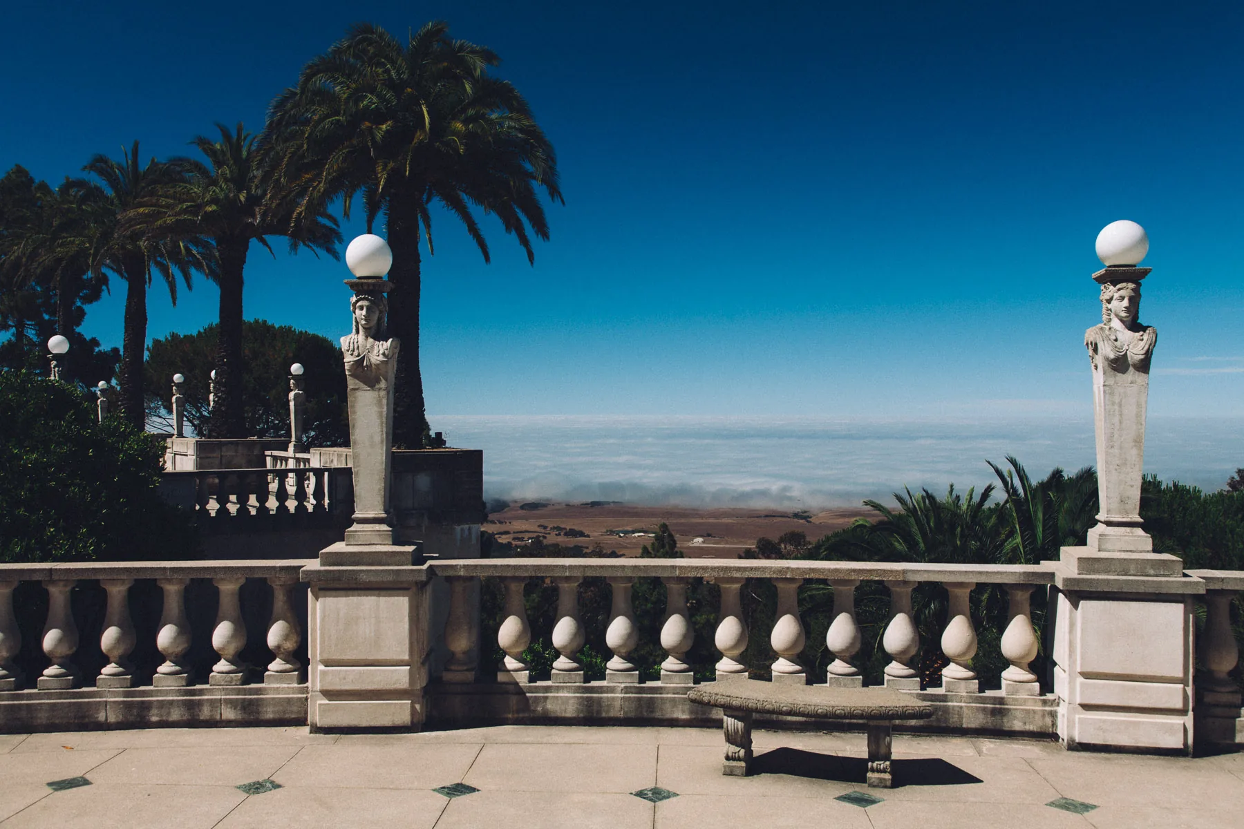 A balustraded terrace with statues above the clouds at Hearst Castle