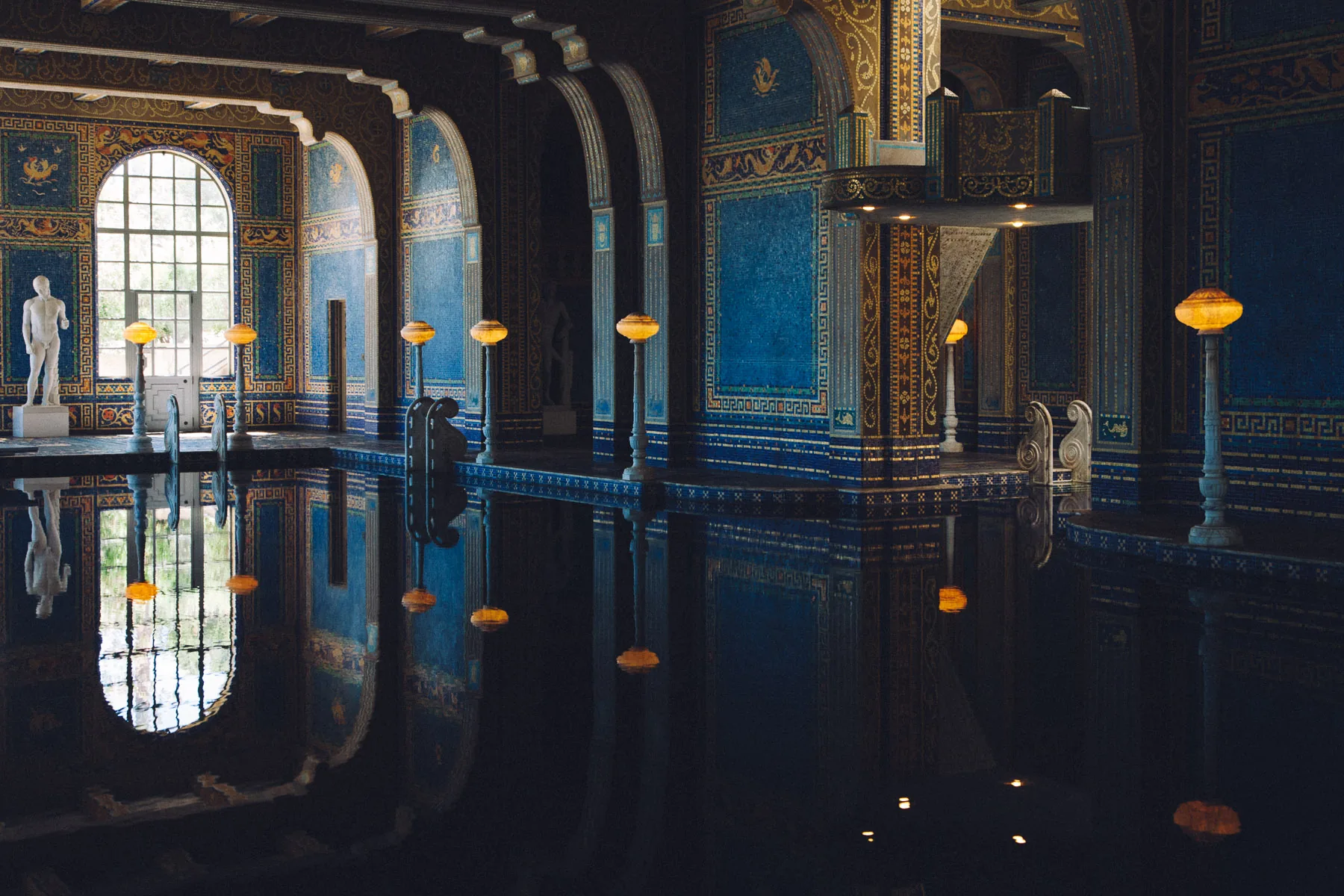 The Roman Pool with its blue and gold mosaics and statues