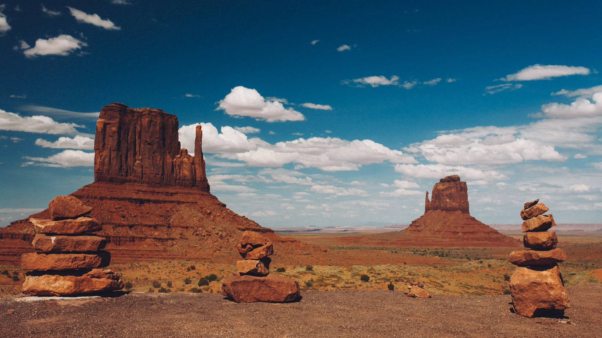 The Mittens buttes beyond small rock piles