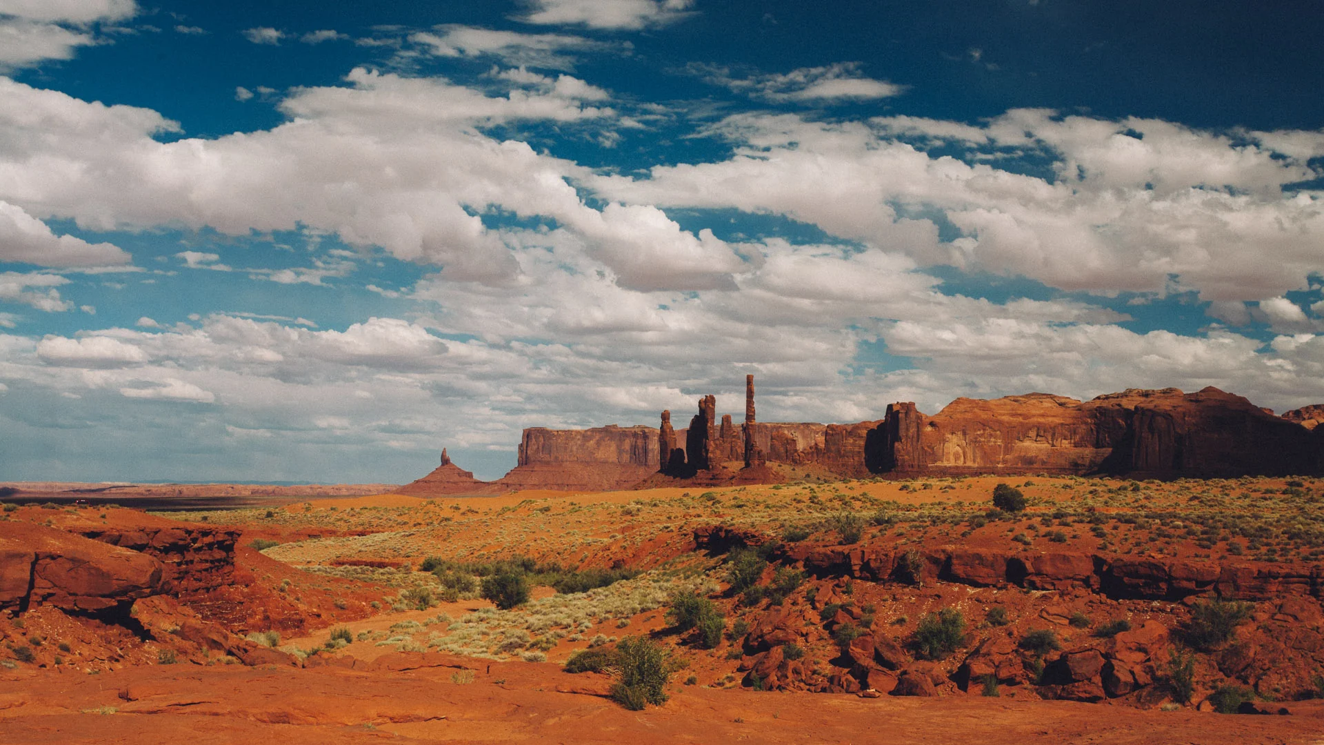 Distant buttes under drifting clouds