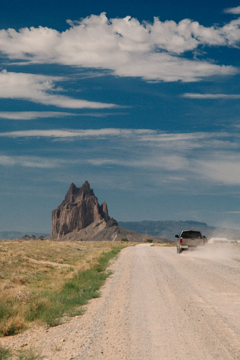 A dirt road leading towards Shiprock