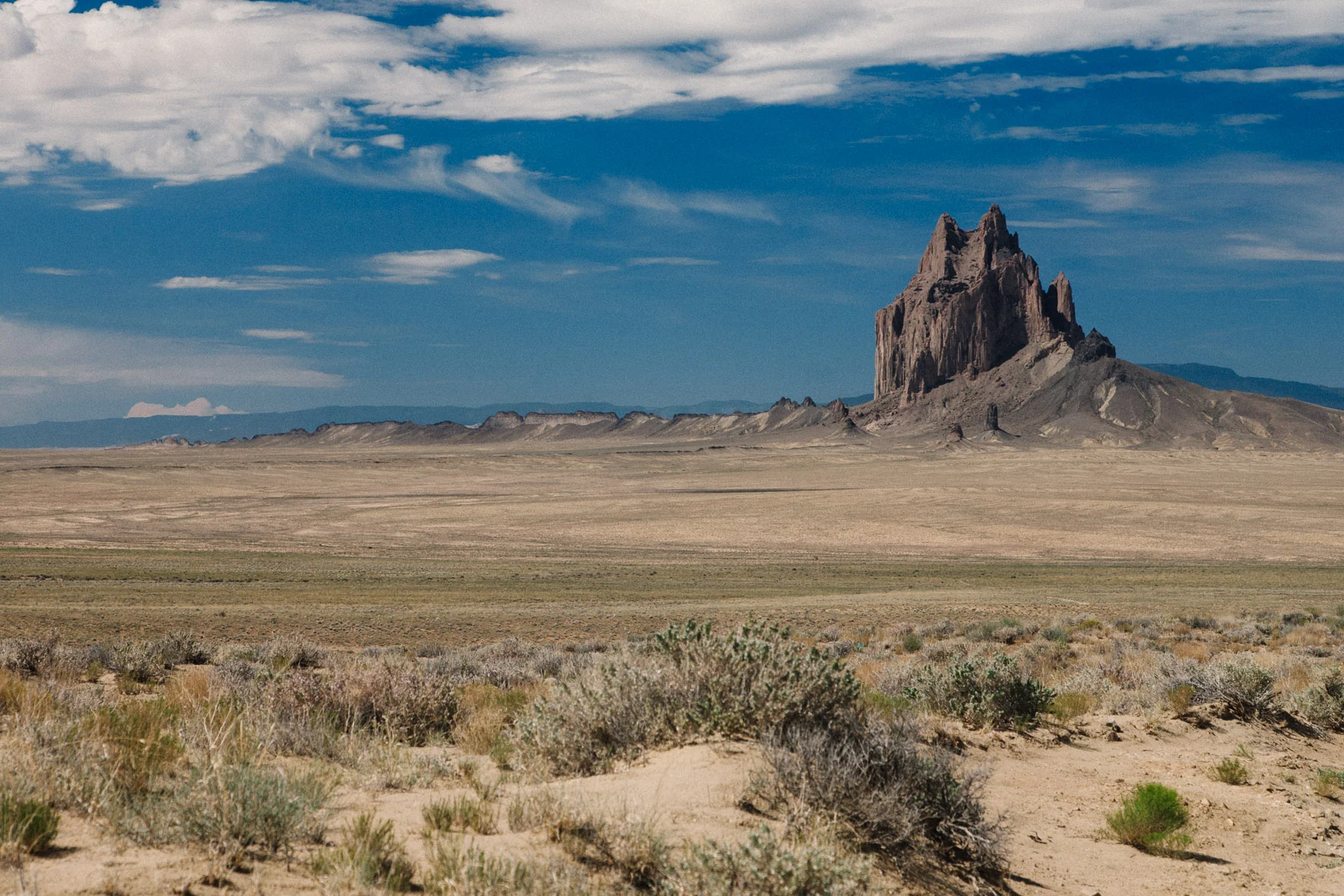Shiprock in perfect light above the desert scrub