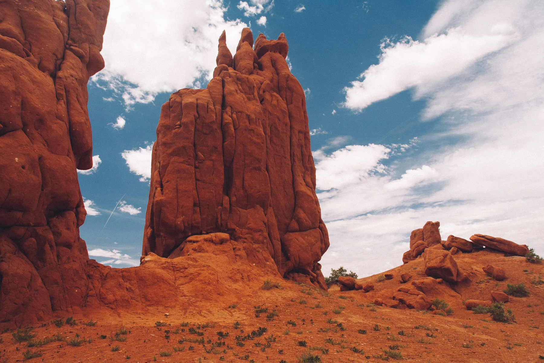 Red rock spires against white clouds