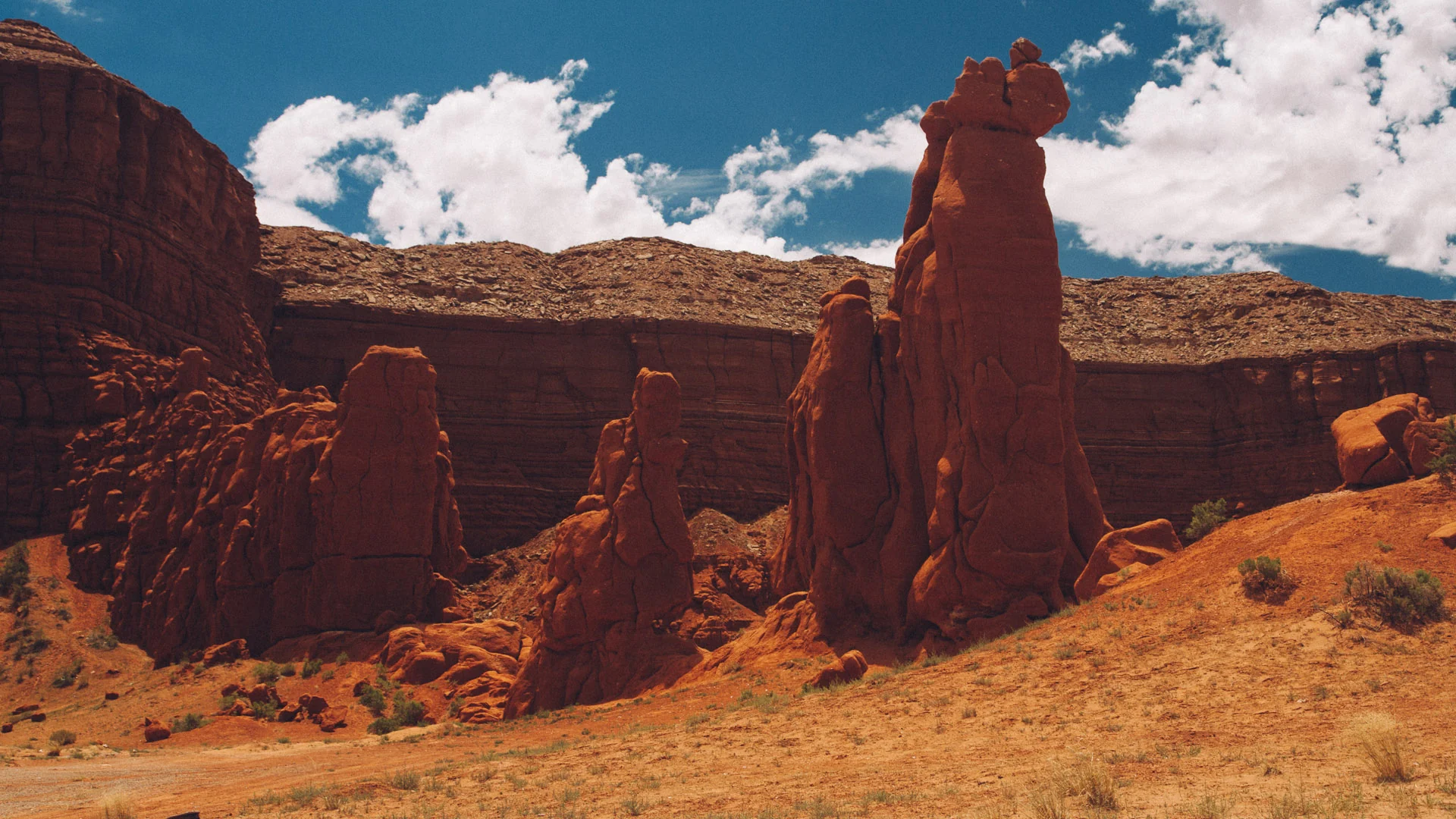 Red rock formations along a desert valley