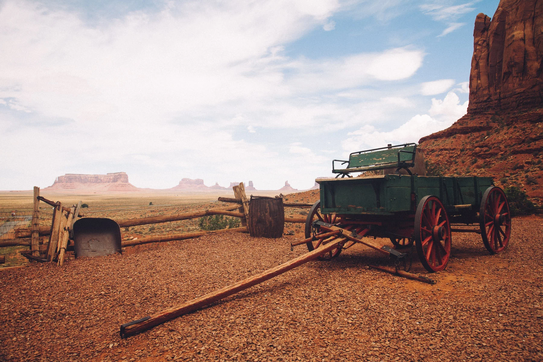 An old wooden wagon by a fence in Monument Valley