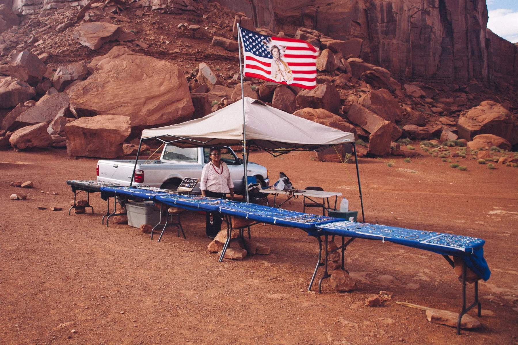 A Navajo vendor's stall with an American flag beneath red rocks