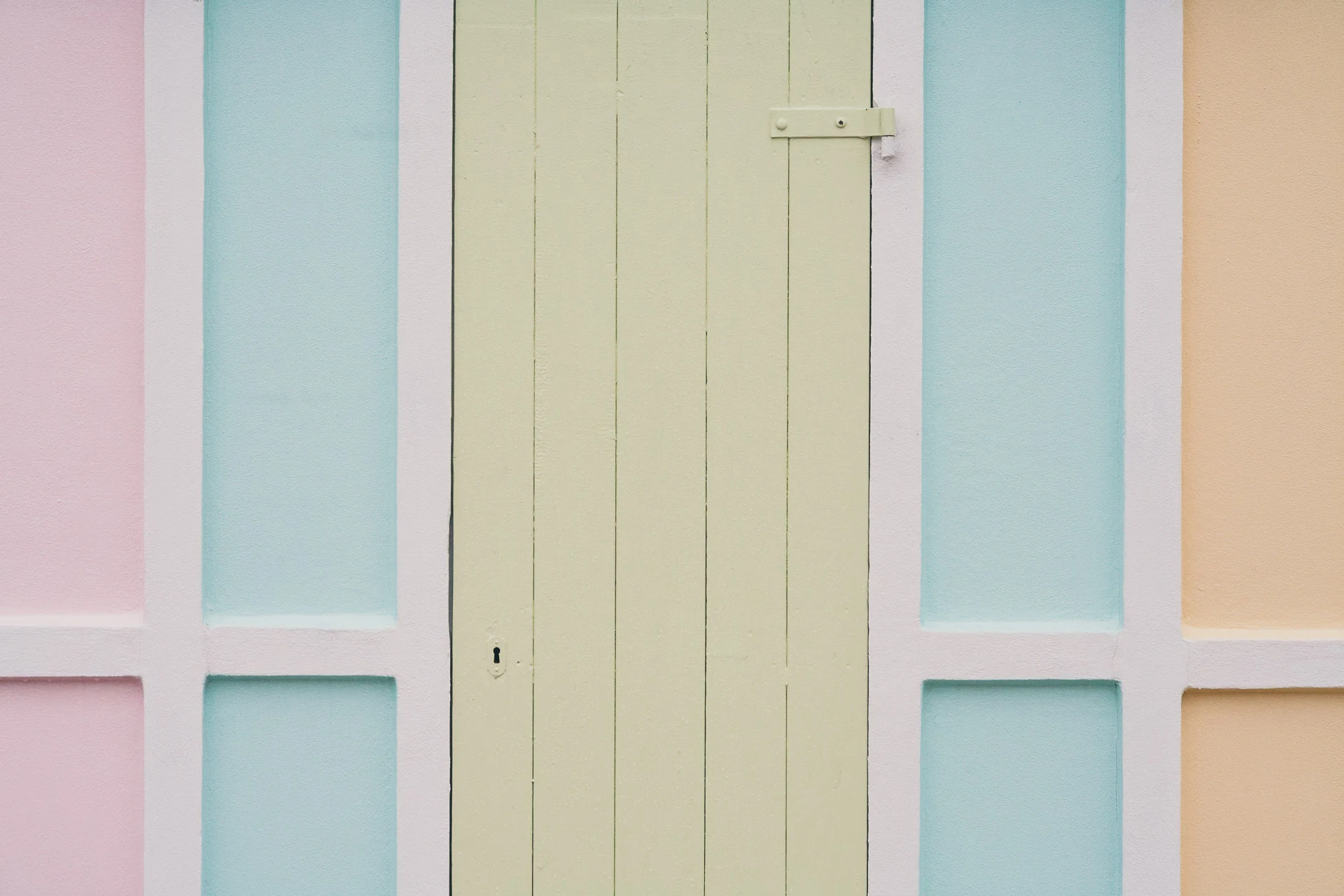 Close view of pastel pink, green and yellow cabin doors