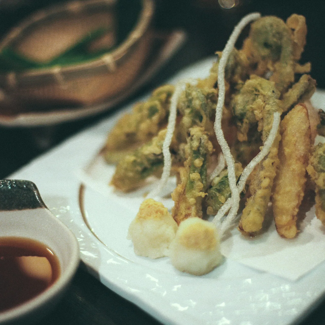 A plate of tempura with dipping sauce