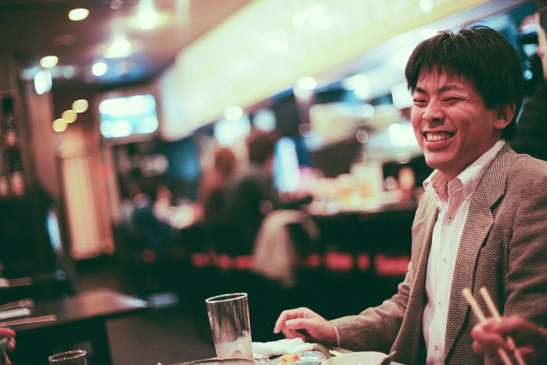 Laughing with chopsticks in hand