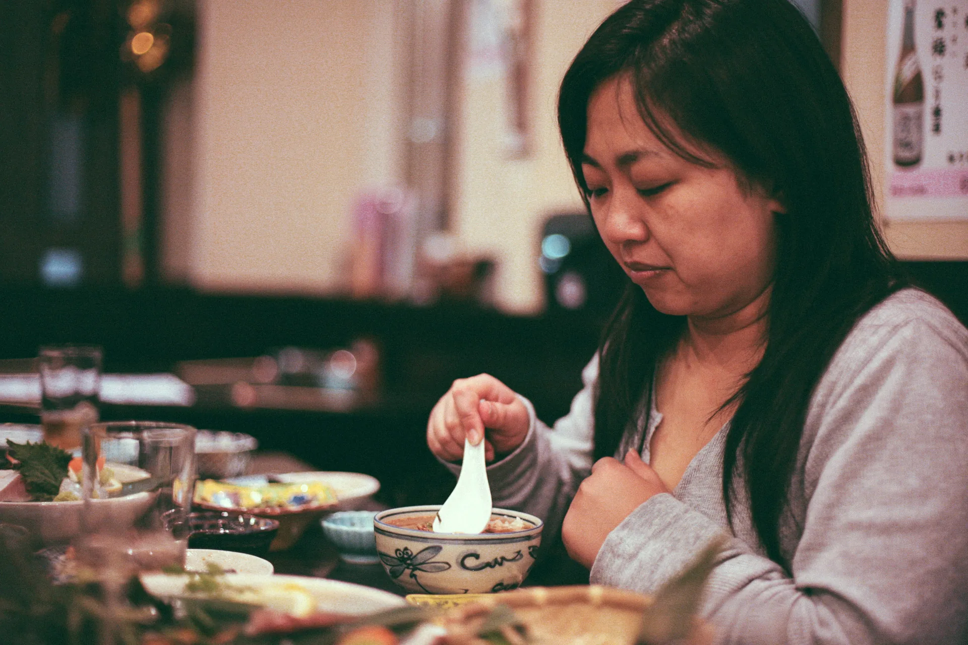Serving herself from a small bowl at dinner