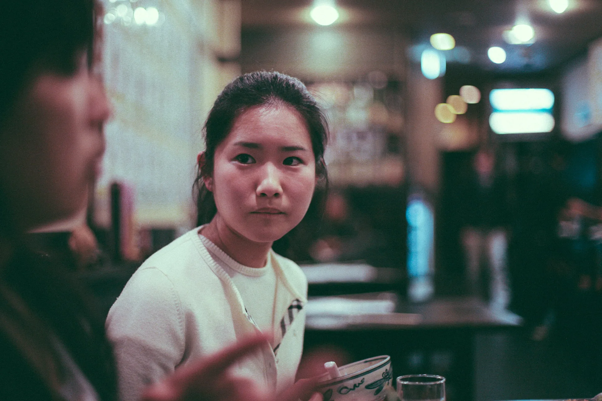 A young woman listening at the table