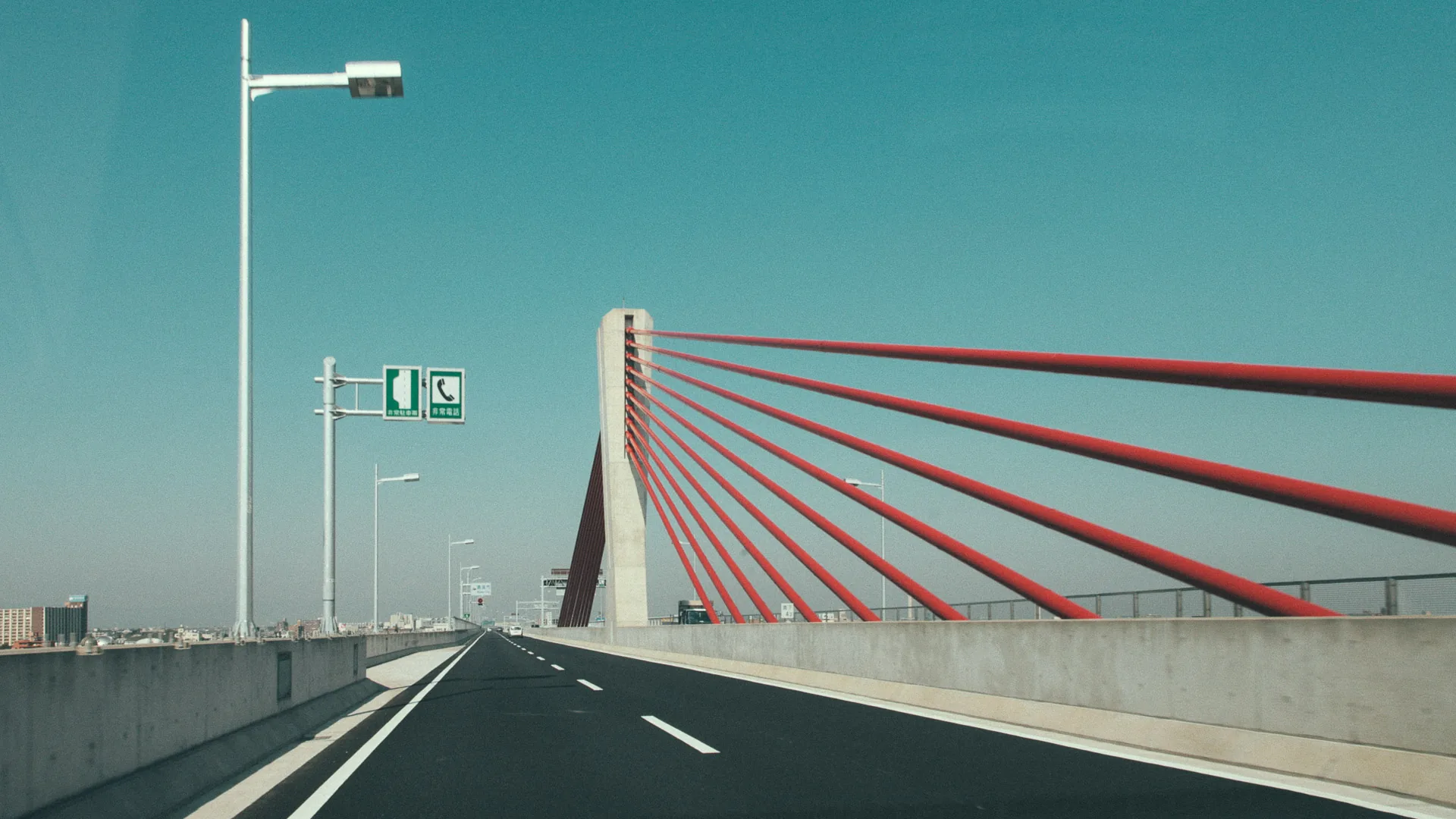 A red cable-stayed bridge on the expressway