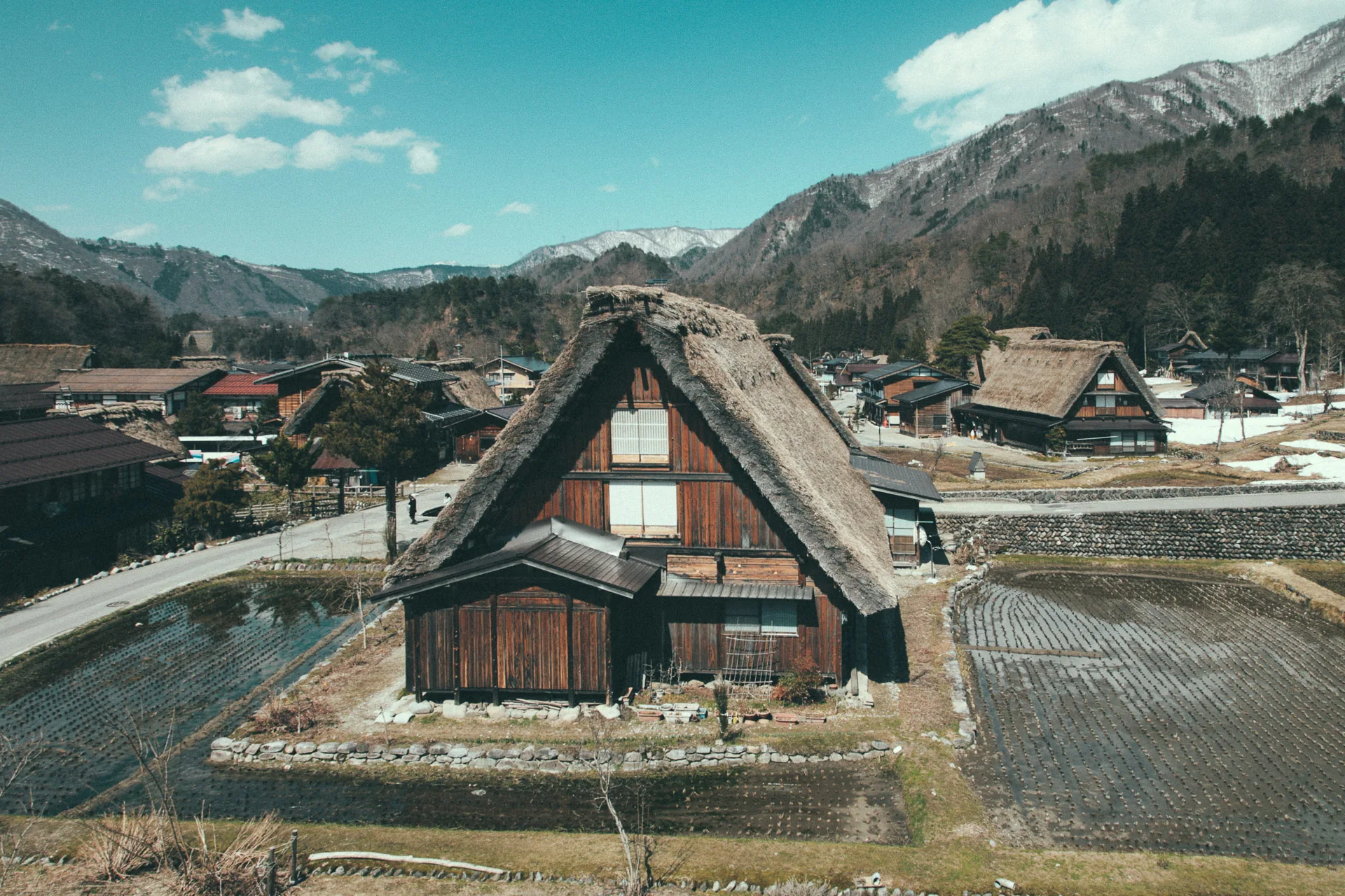 A farmhouse in the valley below the mountains
