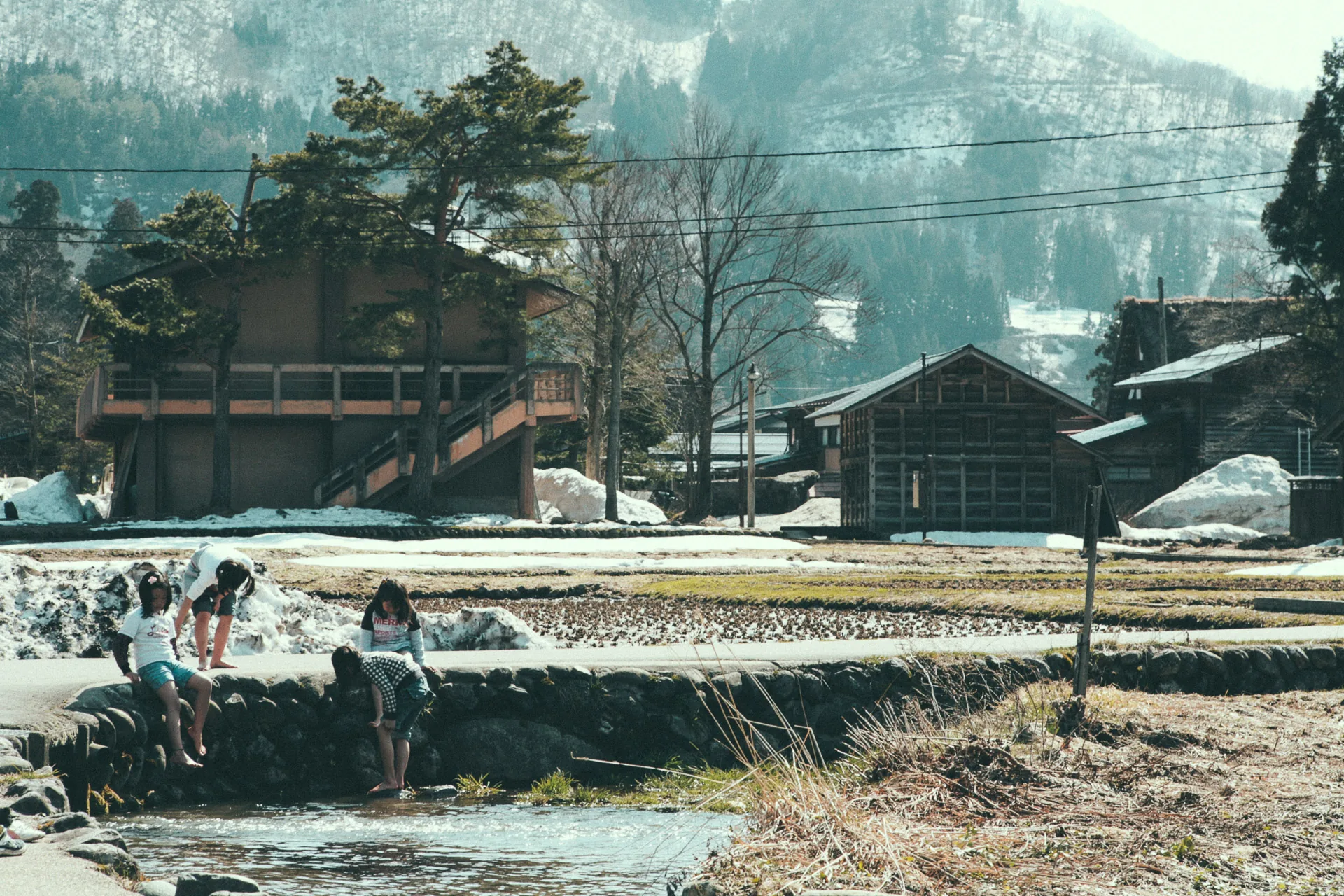 Children playing in the melting snow