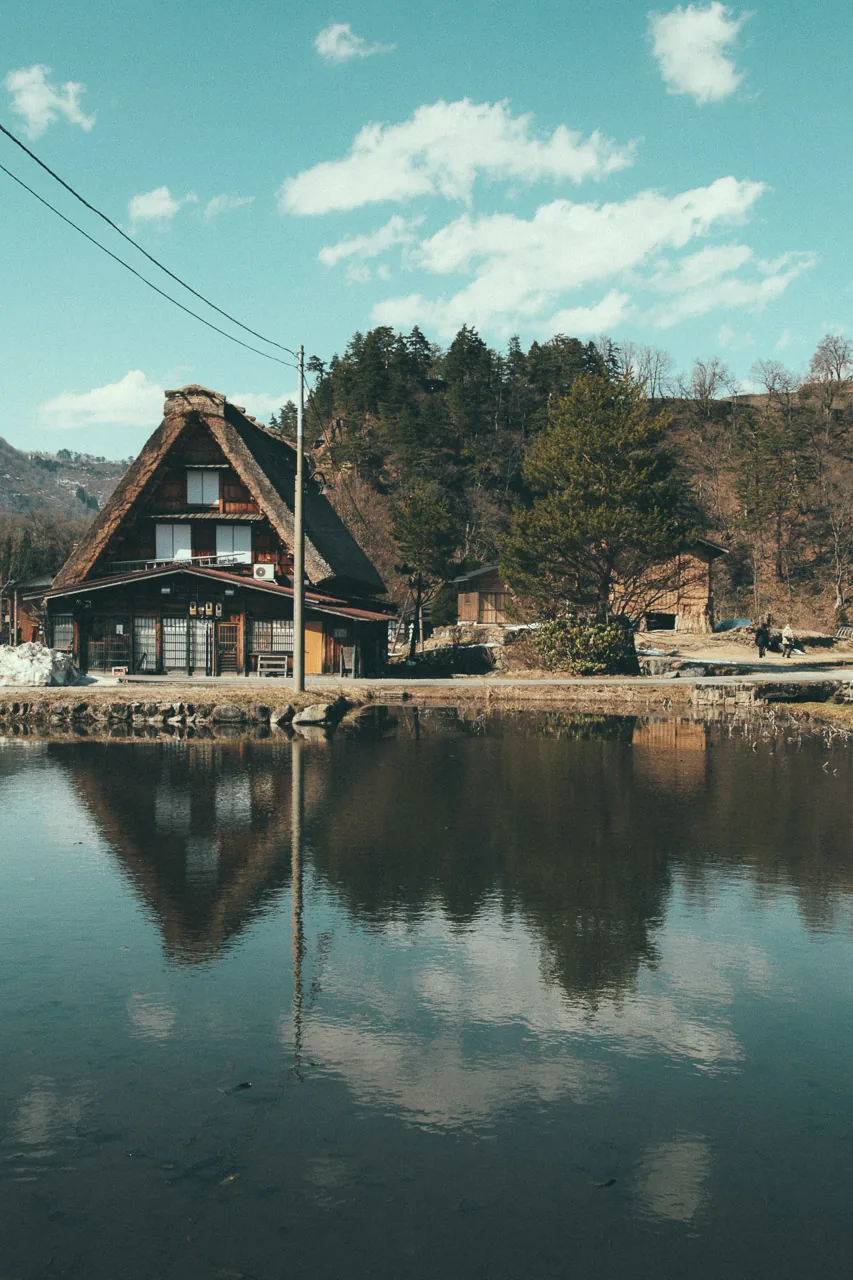 A farmhouse reflected in the water