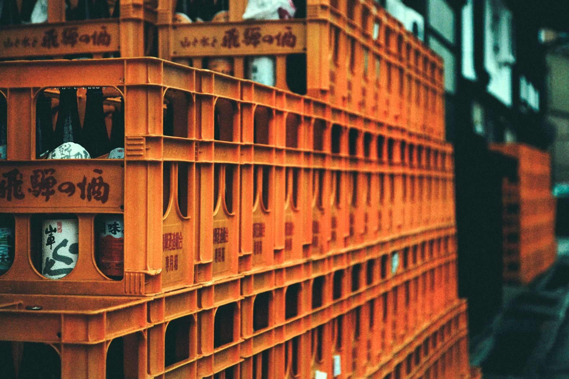 Close-up of orange crates of Hida sake
