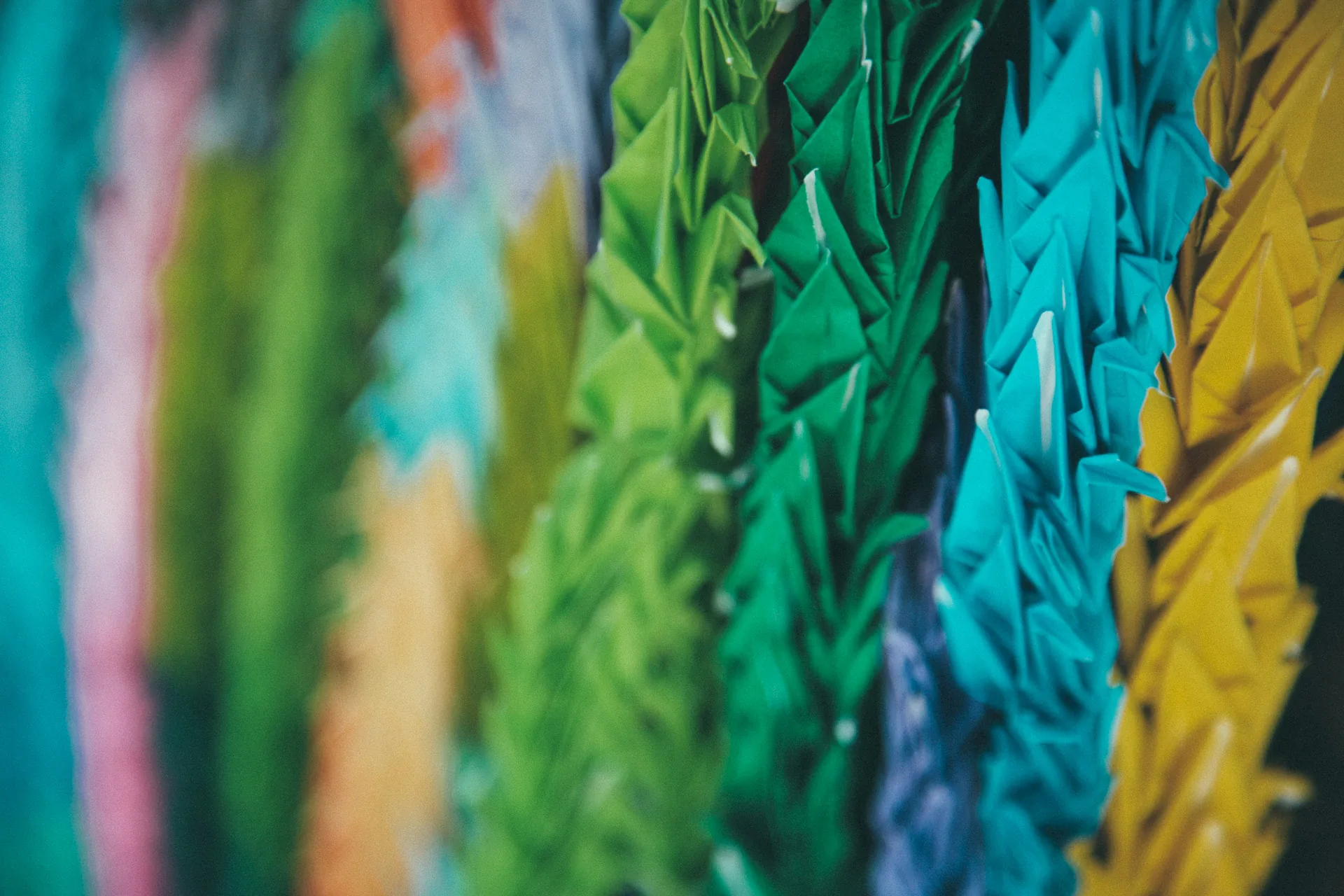 Strings of colourful paper cranes