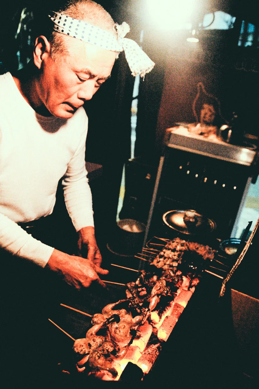 Grilling skewers over glowing charcoal