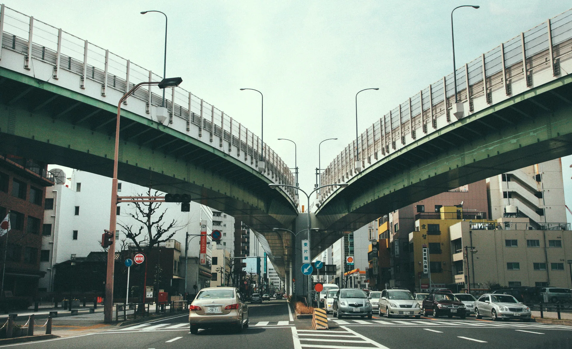Two elevated expressways curving over the road