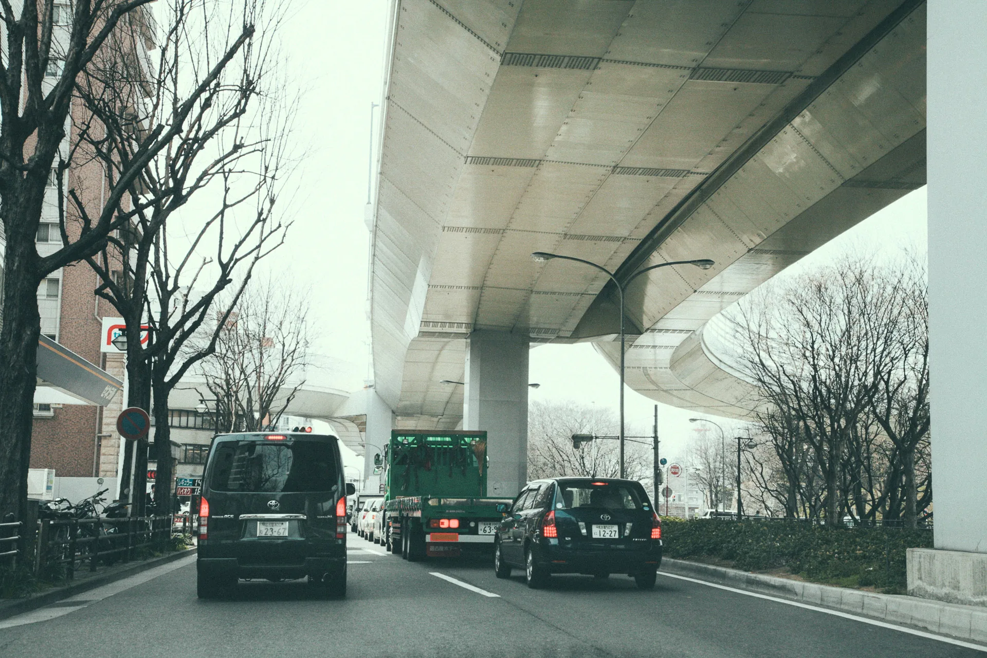 Traffic beneath the concrete underside of an expressway