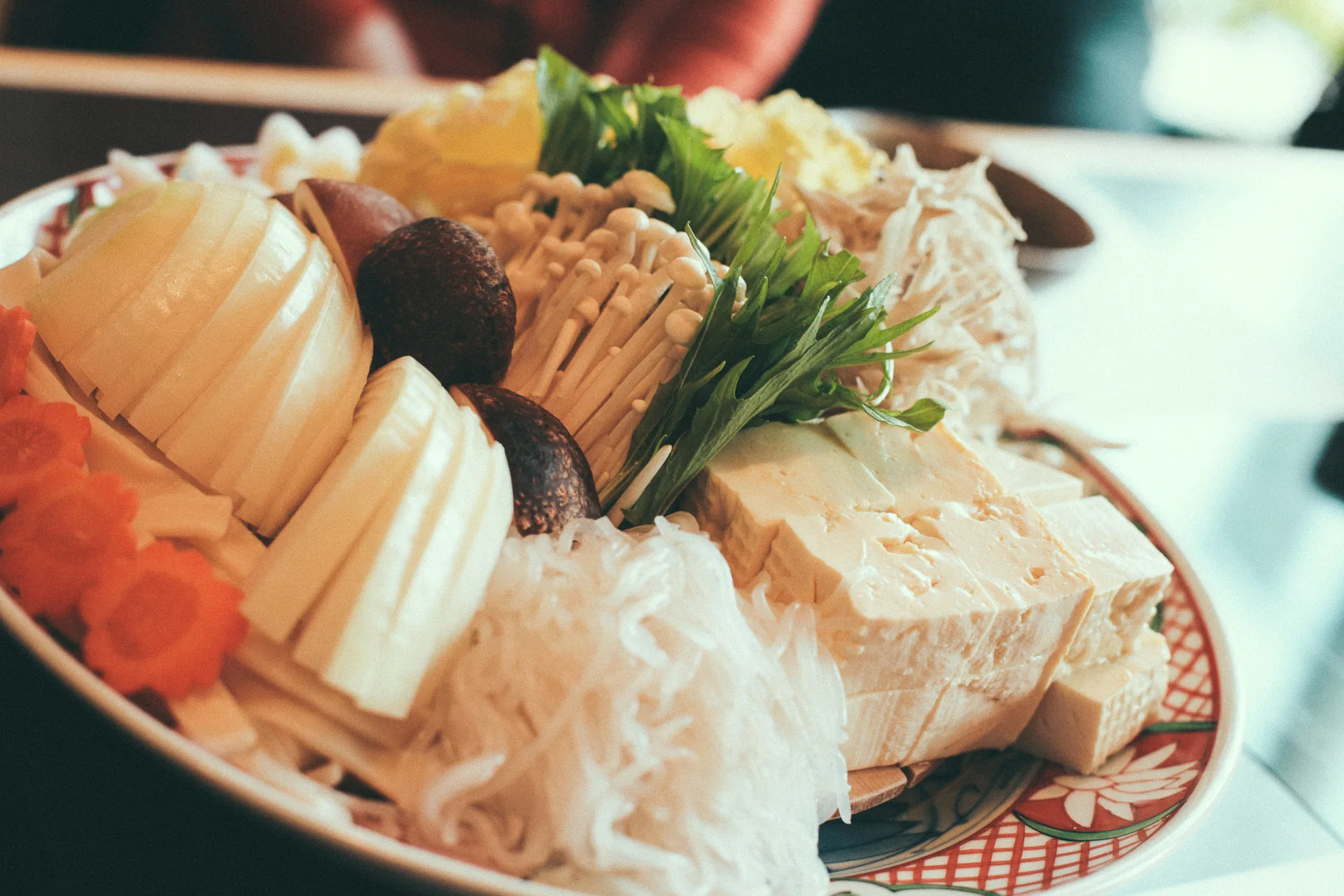 A platter of vegetables, mushrooms and tofu for sukiyaki