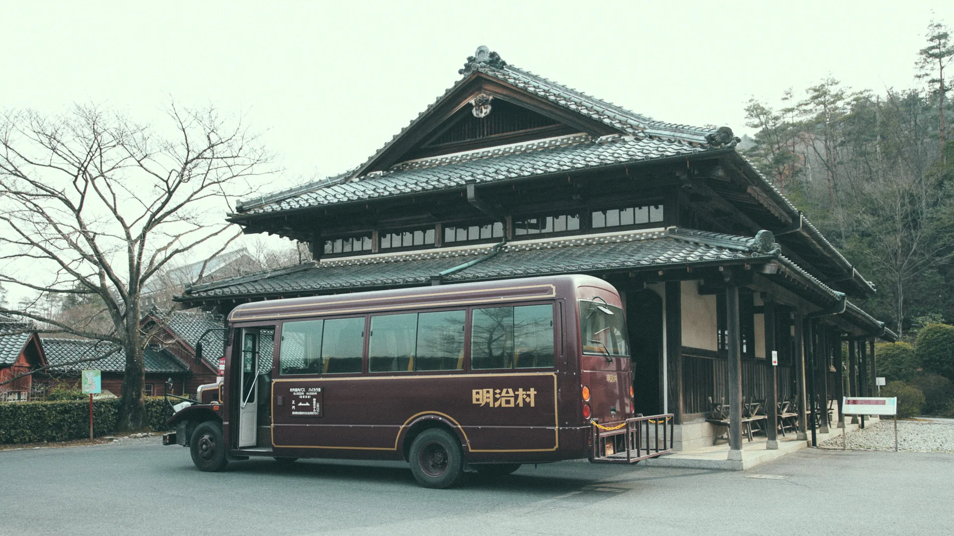 A vintage bus in front of a traditional building