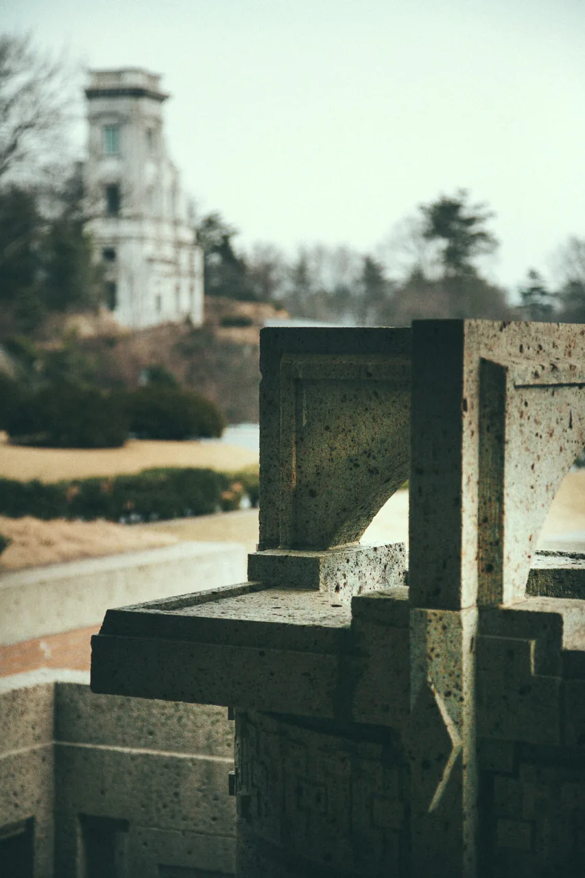 Stone detail of the hotel with a tower beyond