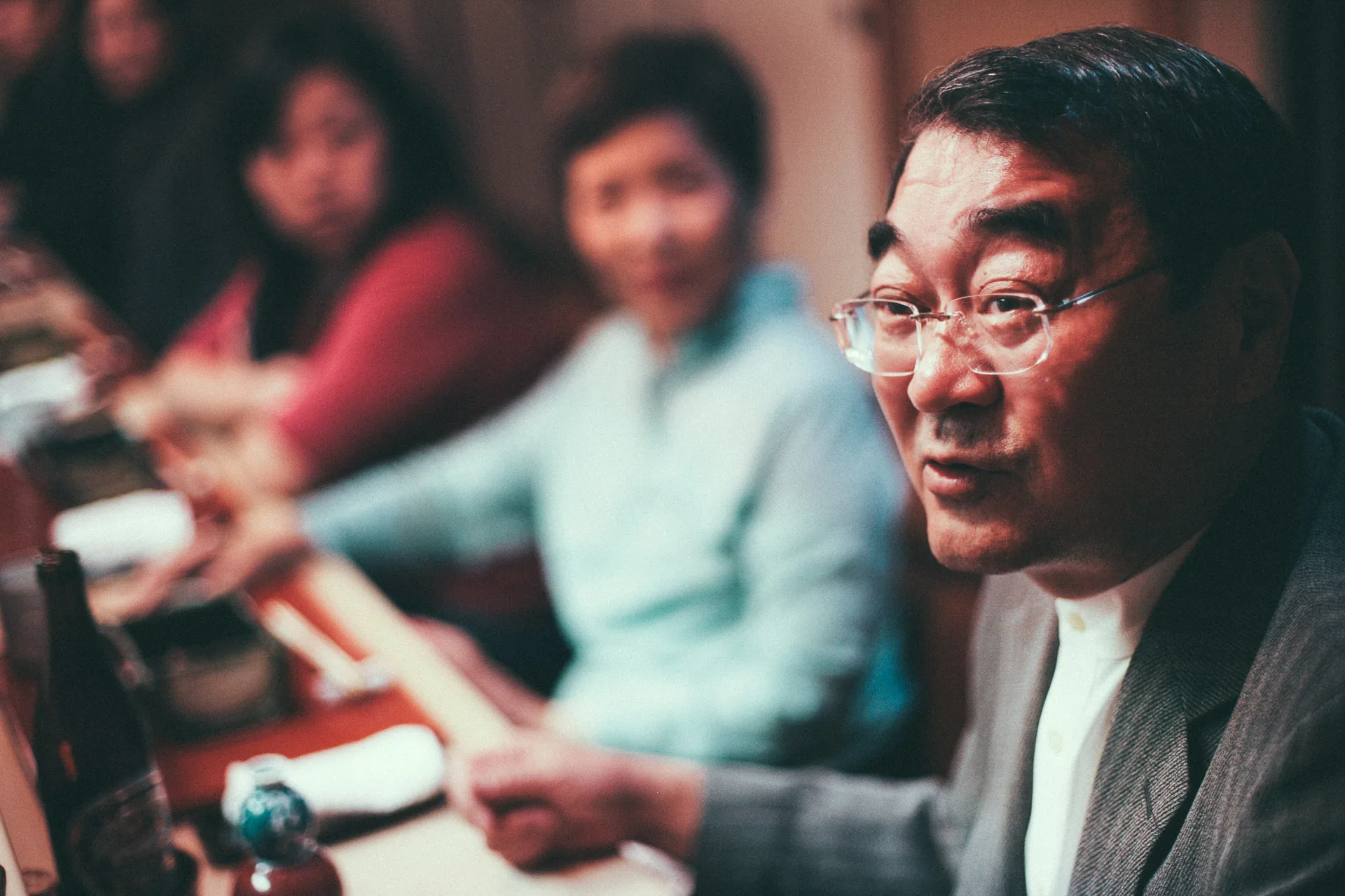 Masao talking at the counter with the family