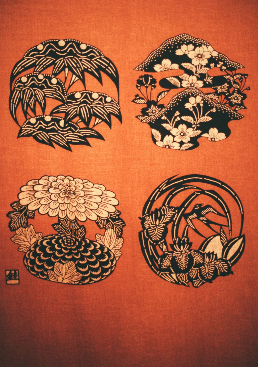 Embroidered family crests on a red cloth