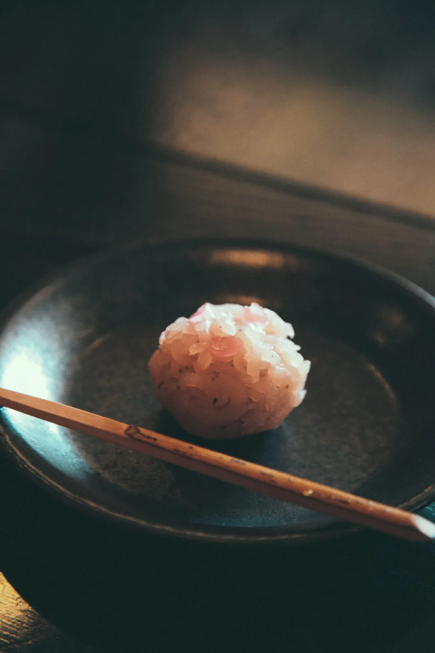 A wagashi sweet on a dark plate