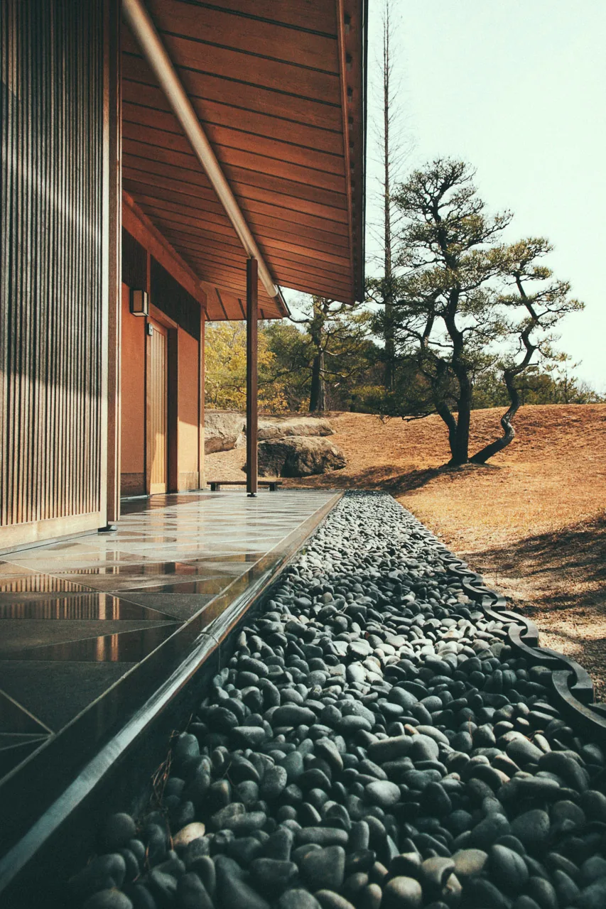 Black pebbles along the tea house wall