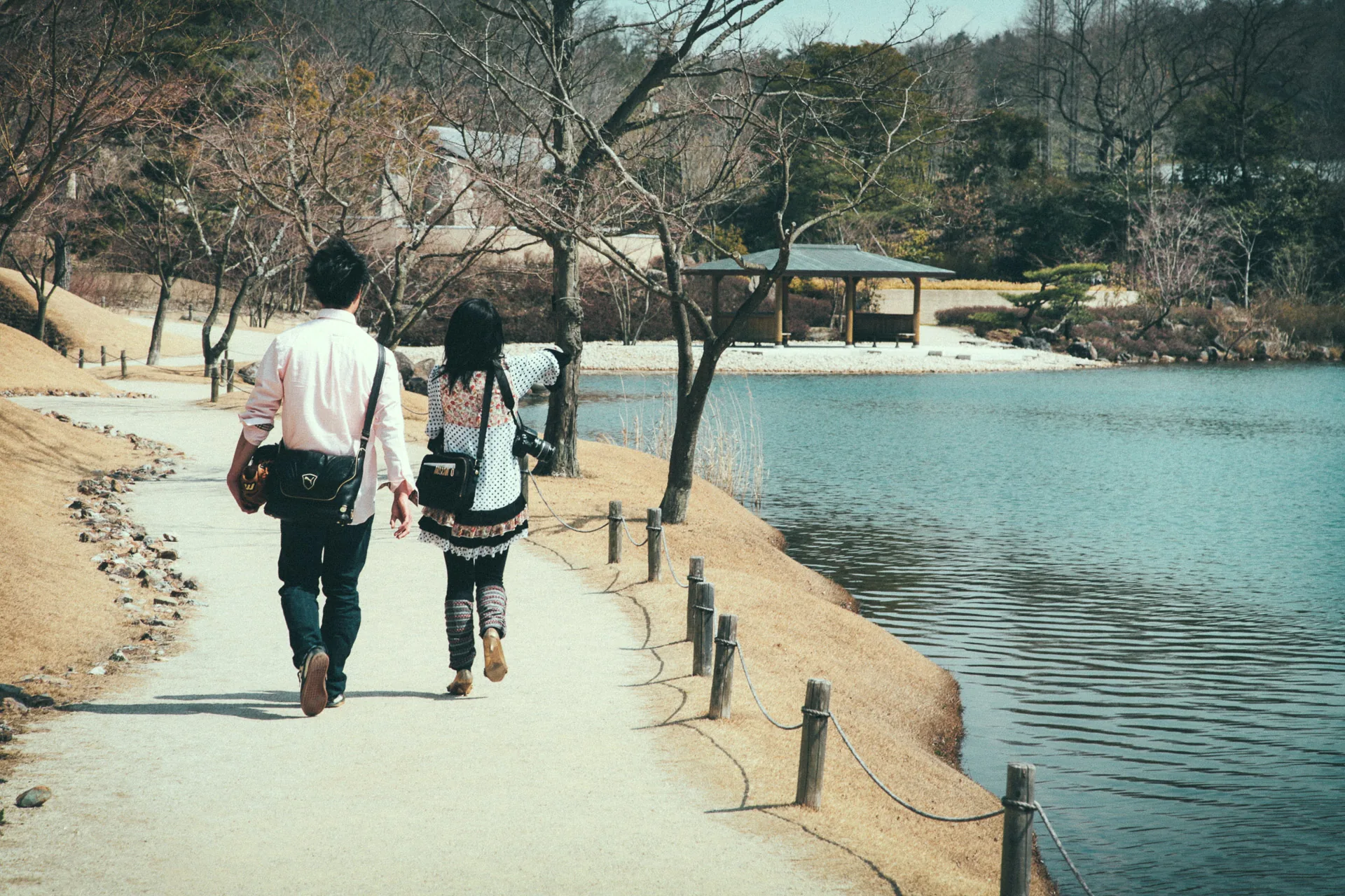 A couple walking along the pond