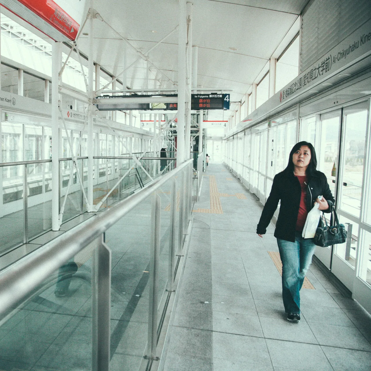 Yasuko walking along the station platform