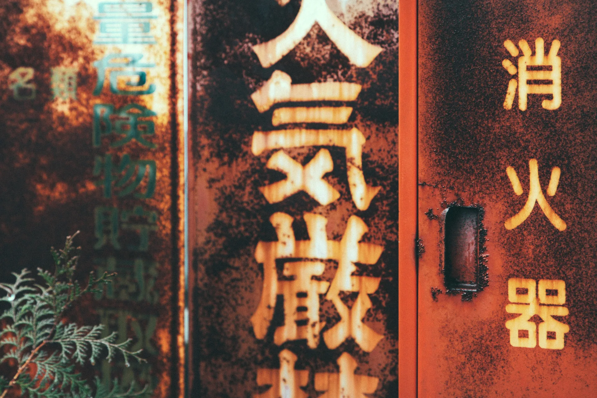 Rusted signs on a red fire hose cabinet