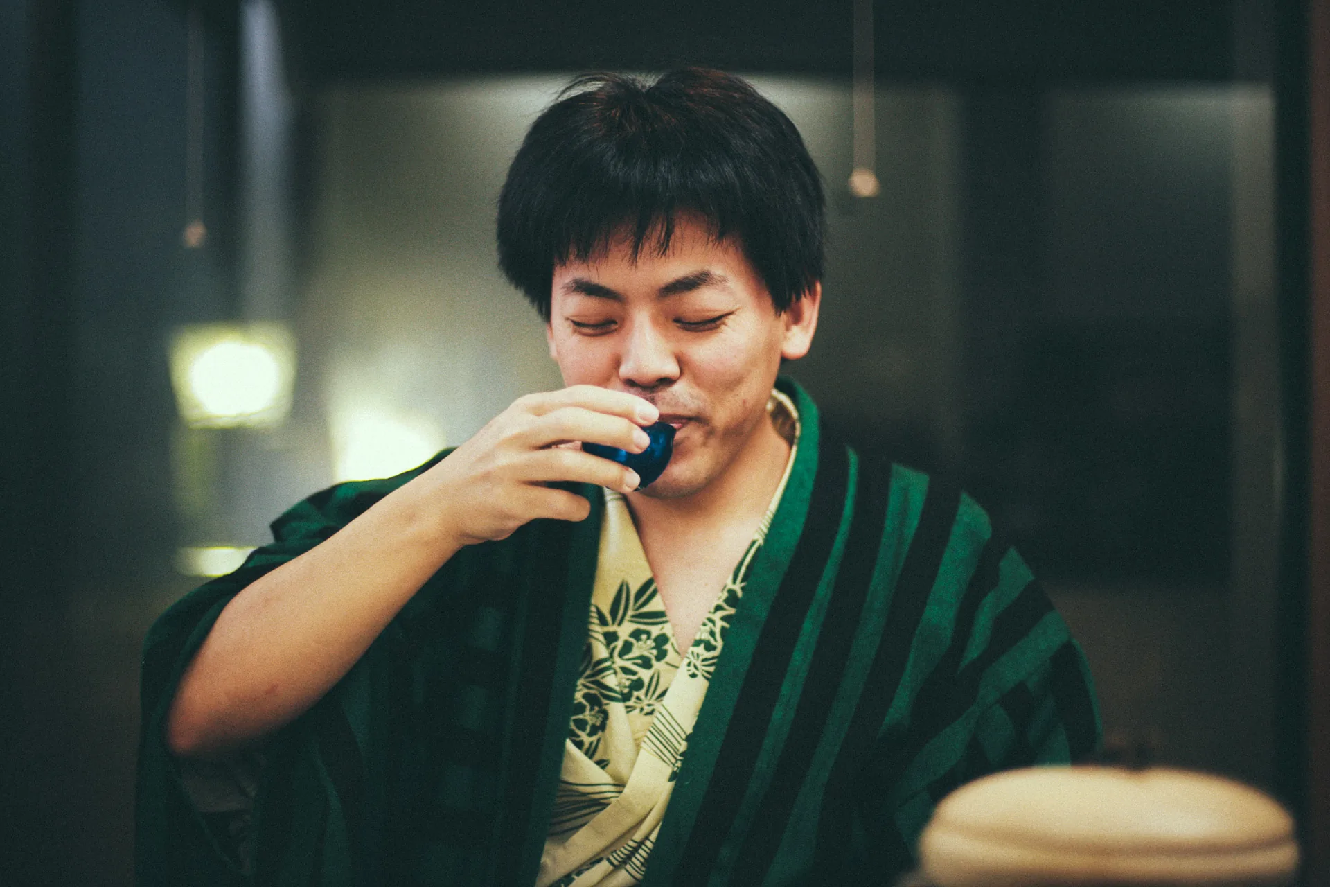 Jutaro sipping sake in a yukata
