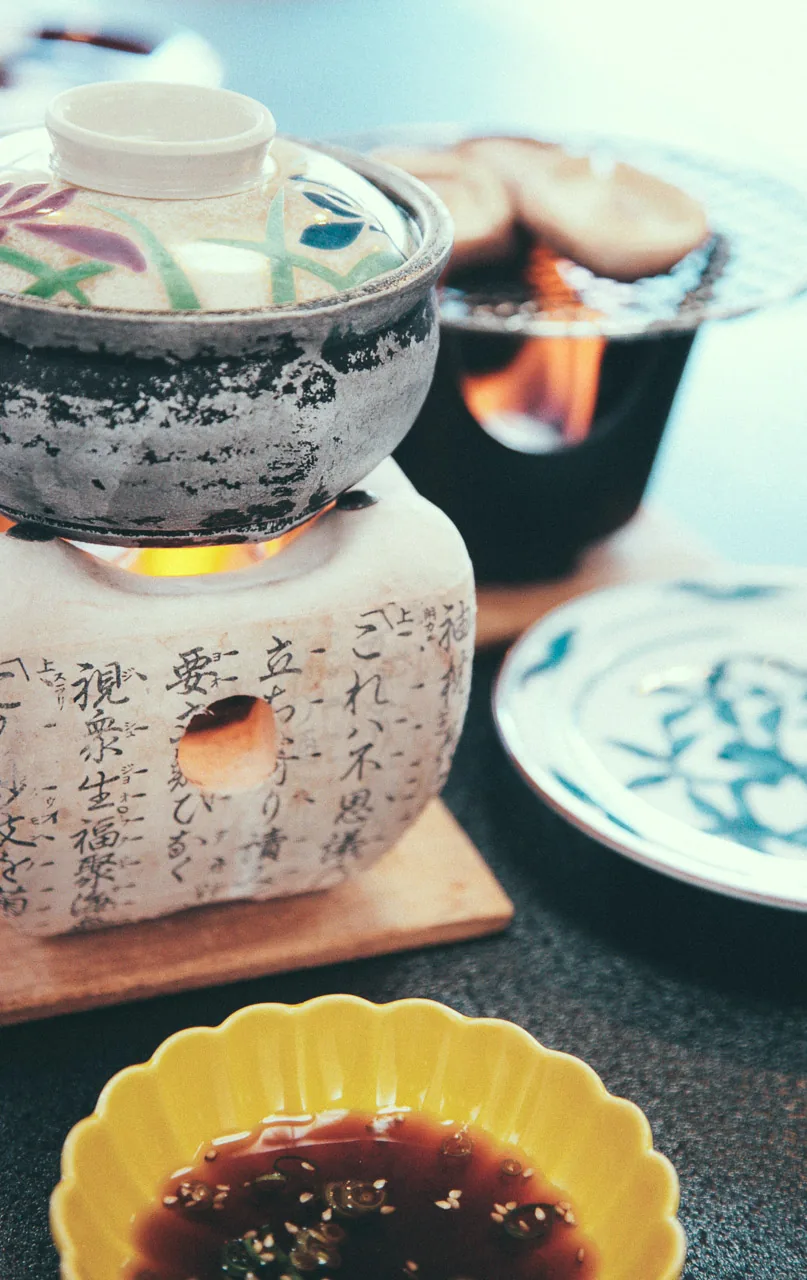 A clay pot over a small burner
