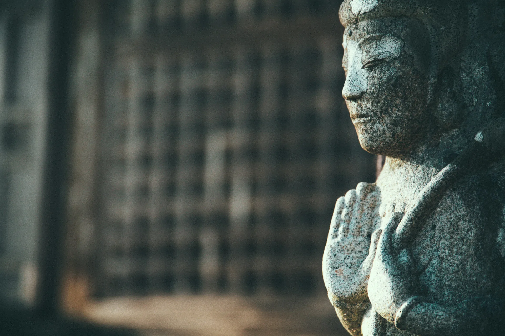 A stone Buddha with joined hands