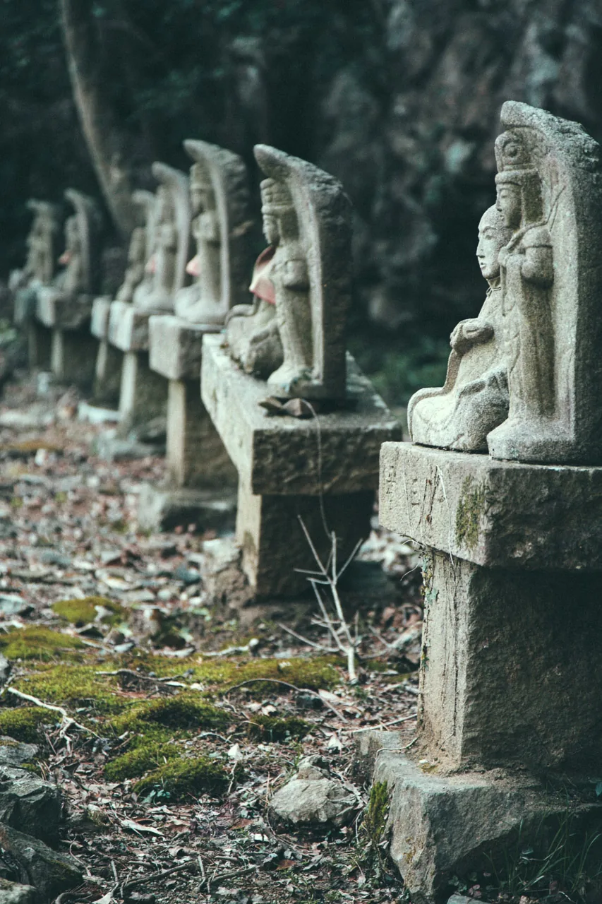 A row of small stone Buddhas