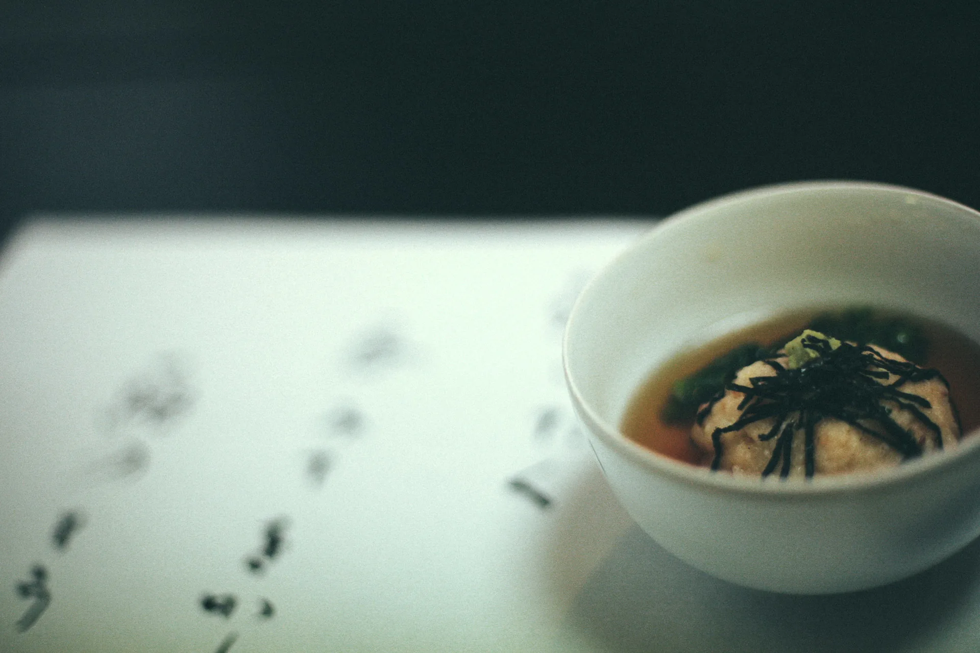 A bowl of soup on the menu card