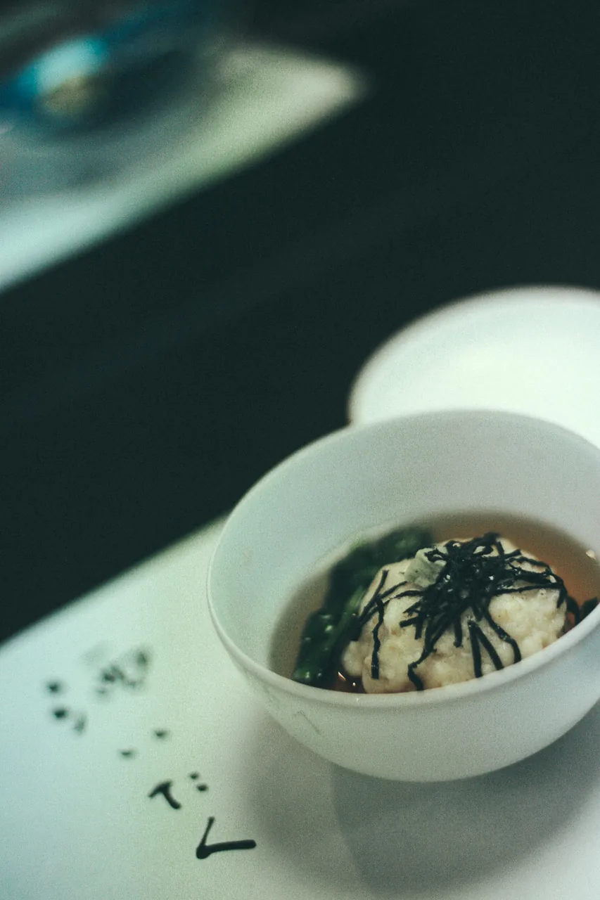 A bowl of soup with seaweed