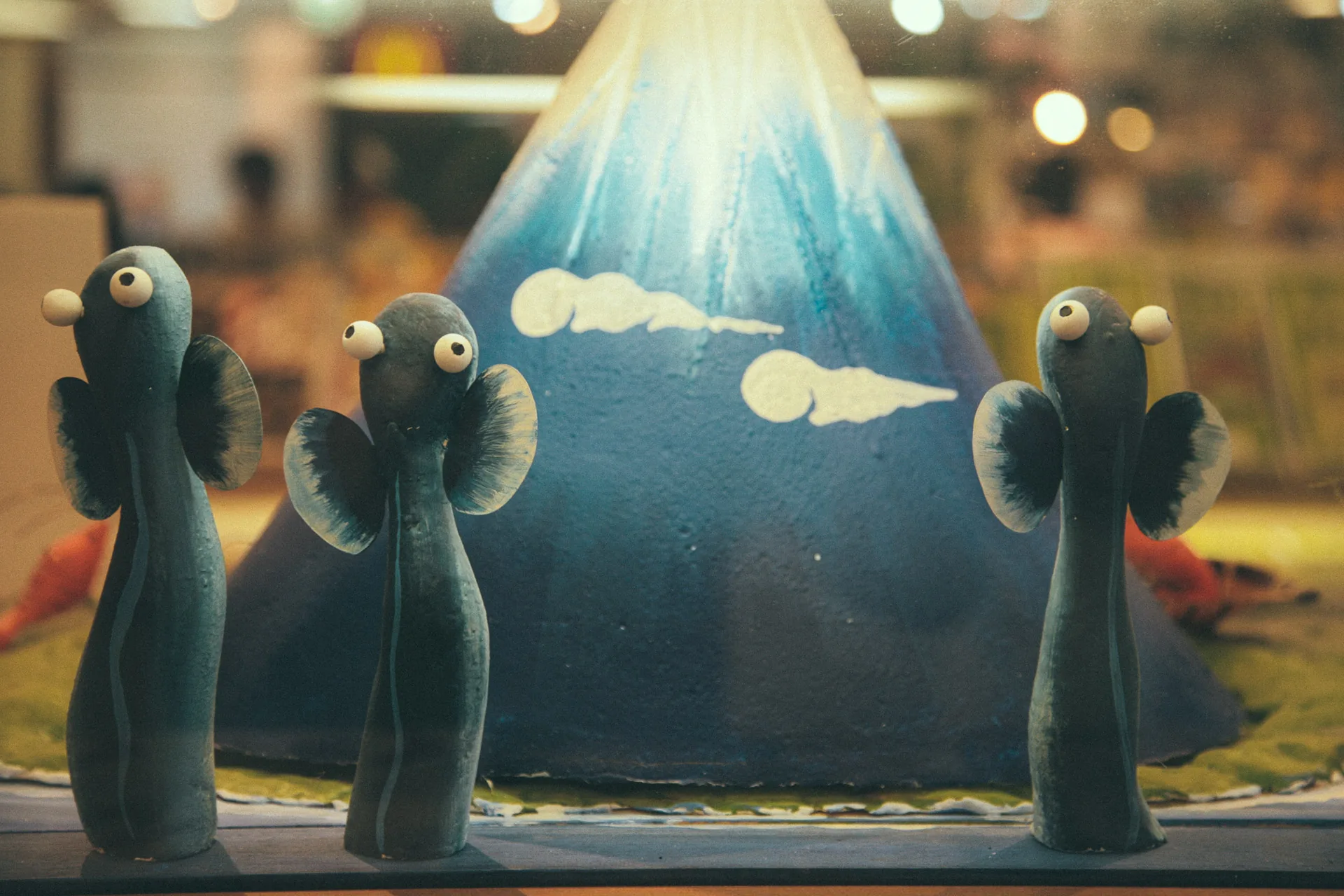 Eel figurines in front of a Mount Fuji display