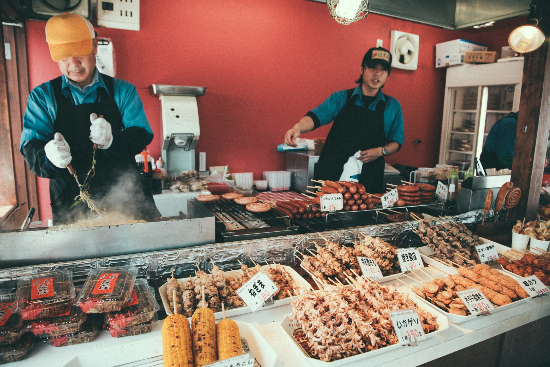Grilling skewers at an outdoor food stand